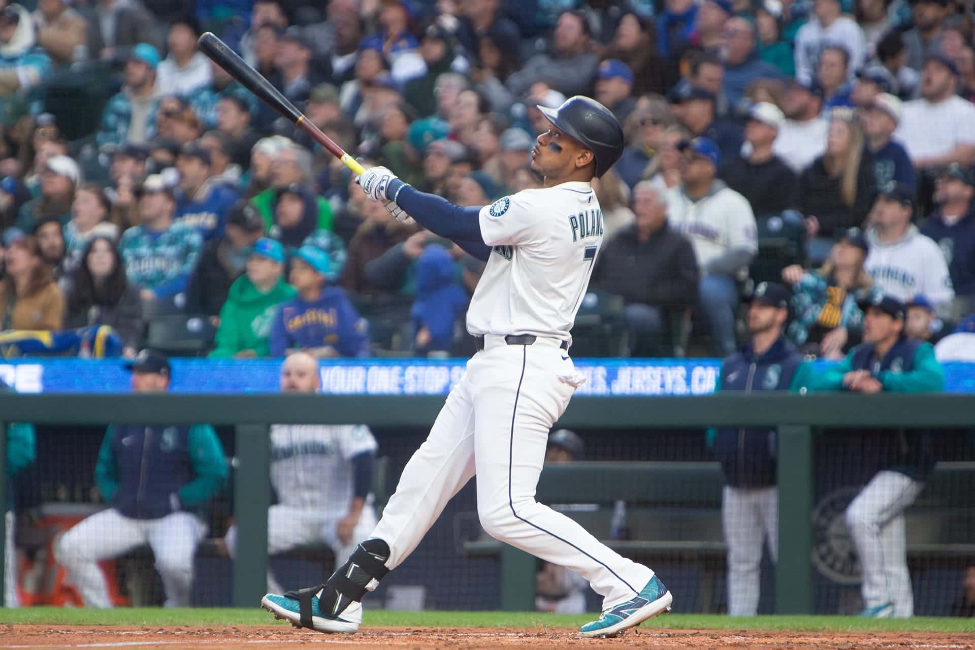 Mariners hitter following through on a swing with his eyes still on the ball