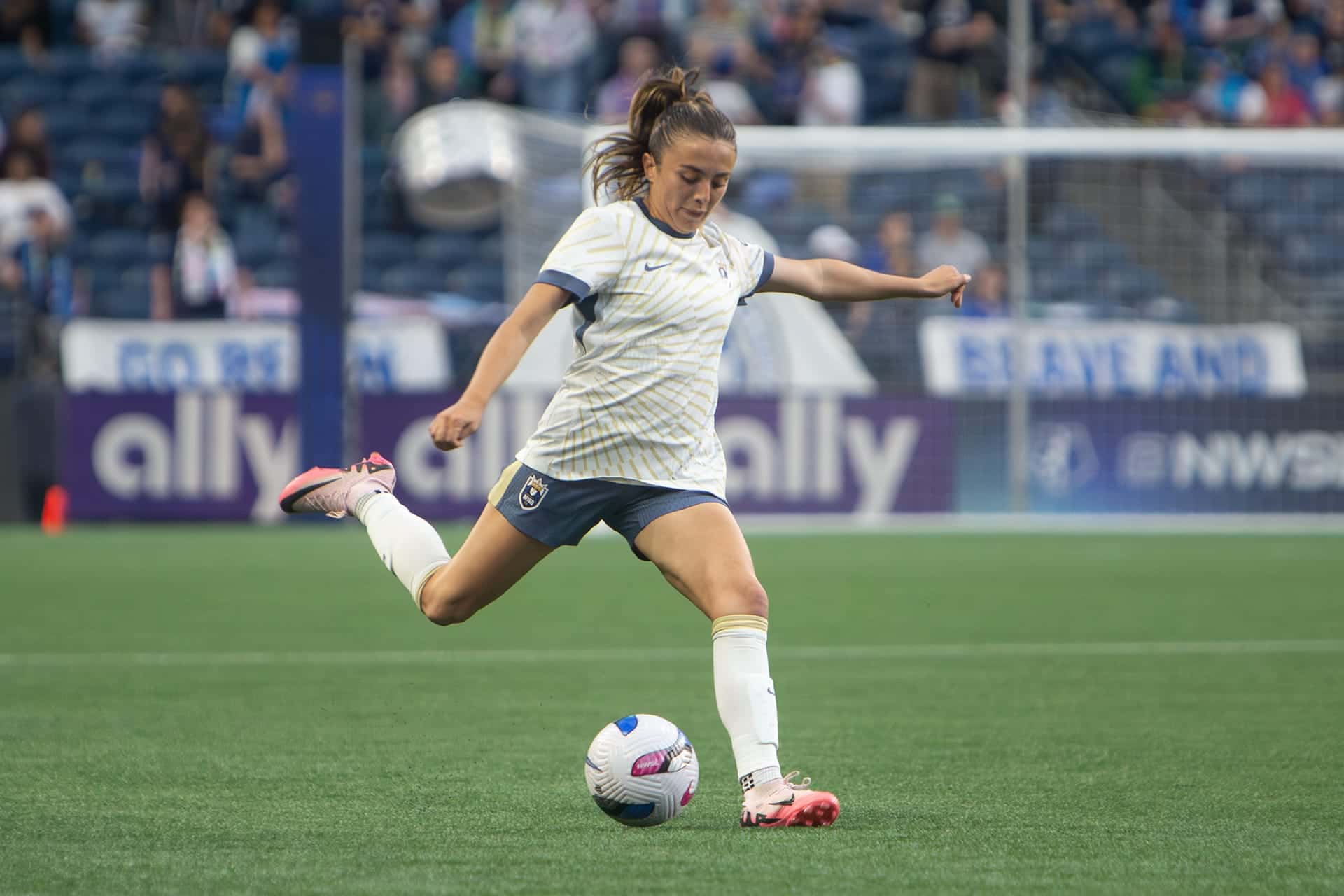 Seattle Reign player winding up to strike the ball during a home match