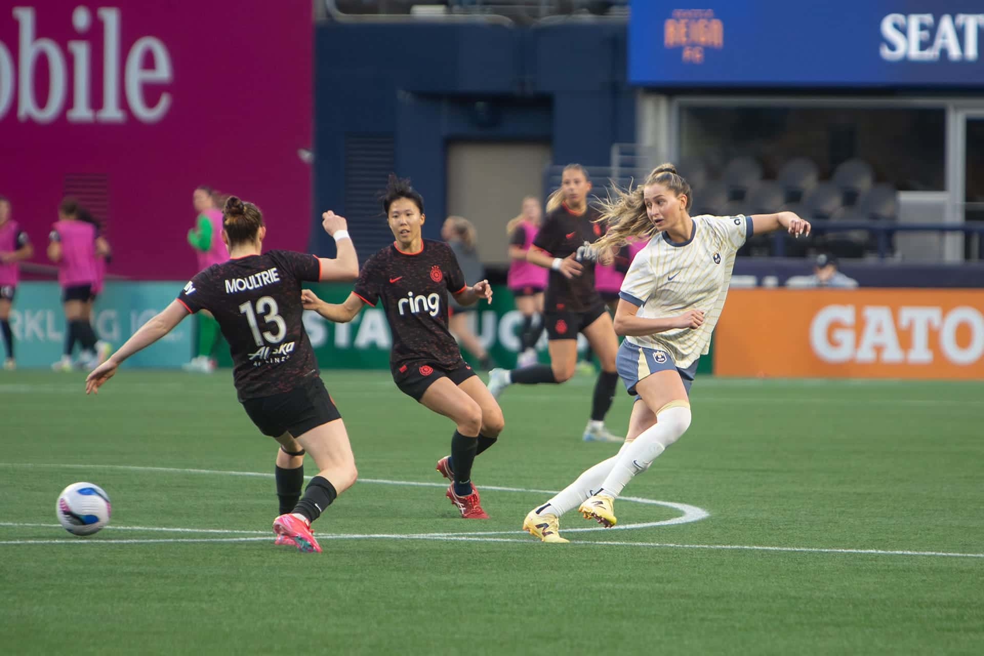 Reign player chasing down an opponent as the ball is carried upfield