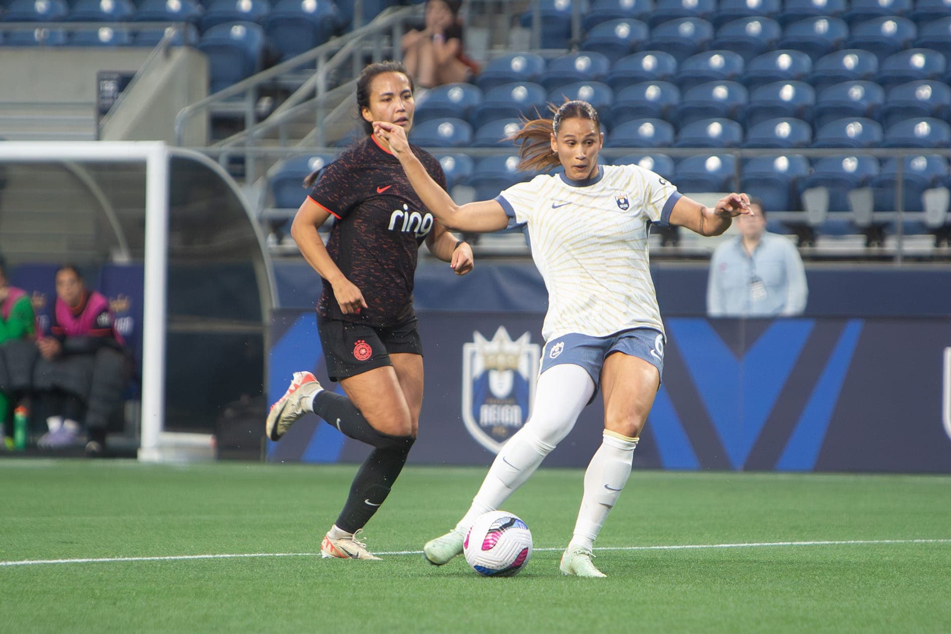 Reign player cutting inside past a defender