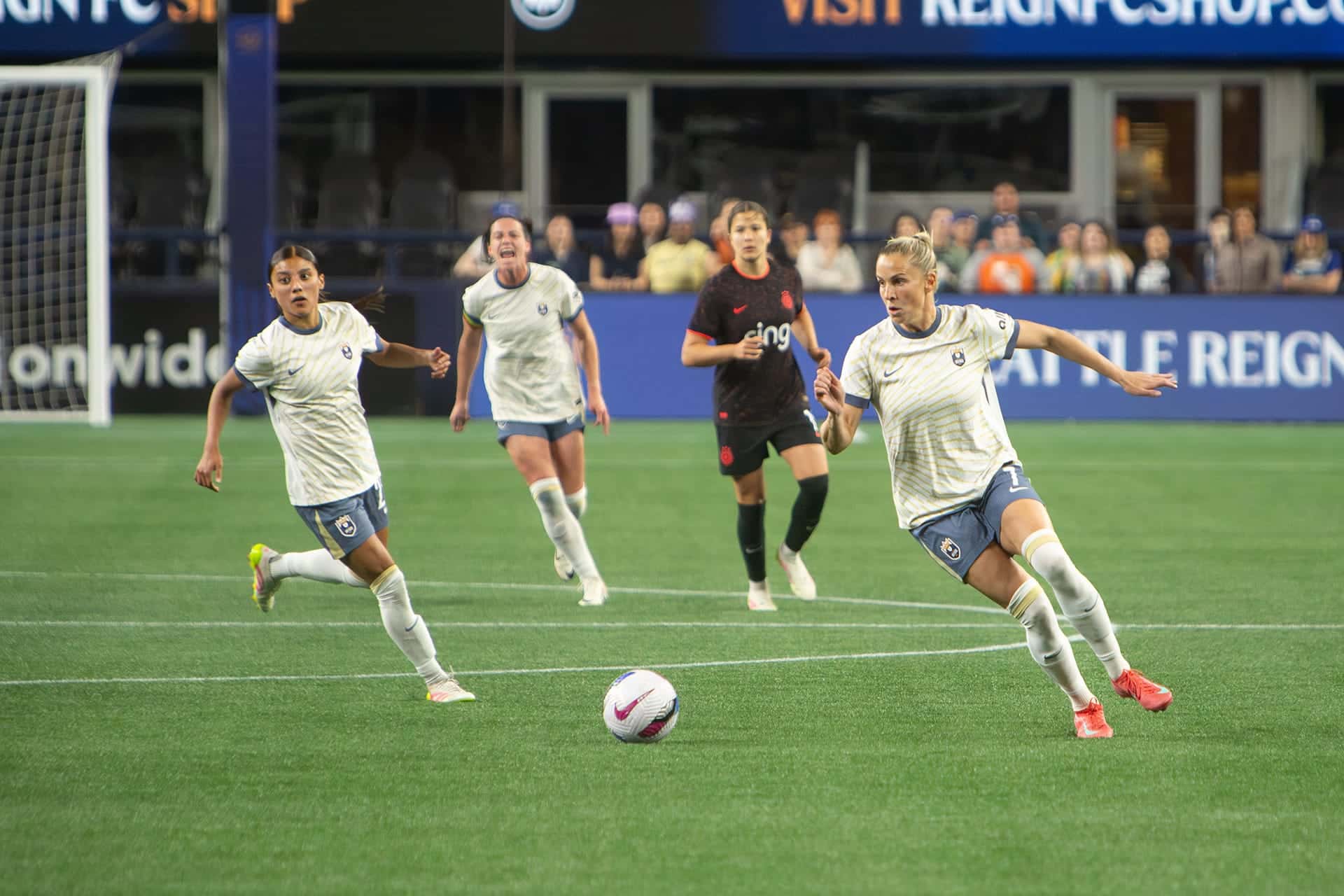 Reign players moving up the field together during an attack