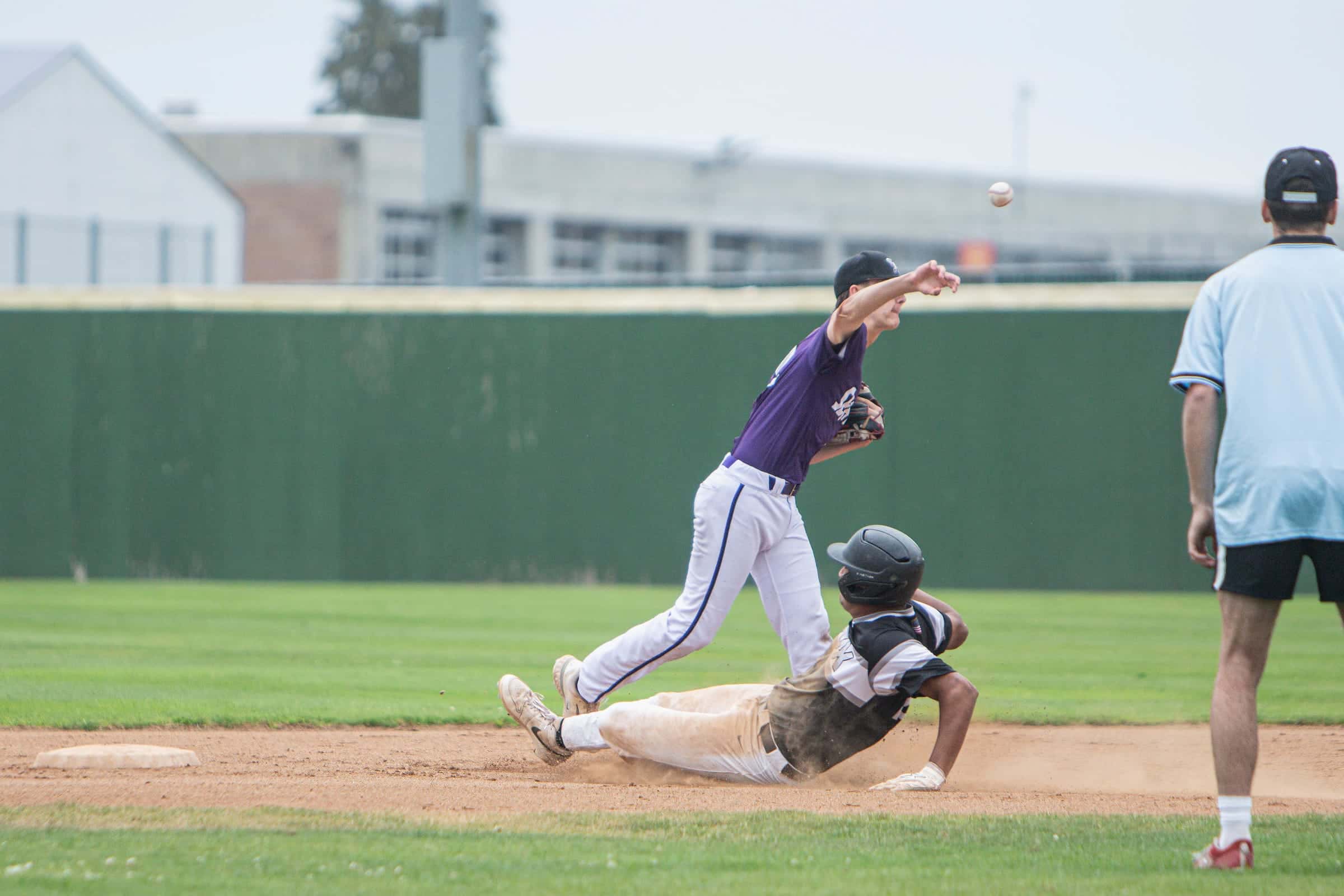 Infielder applying a tag as a runner slides into the base