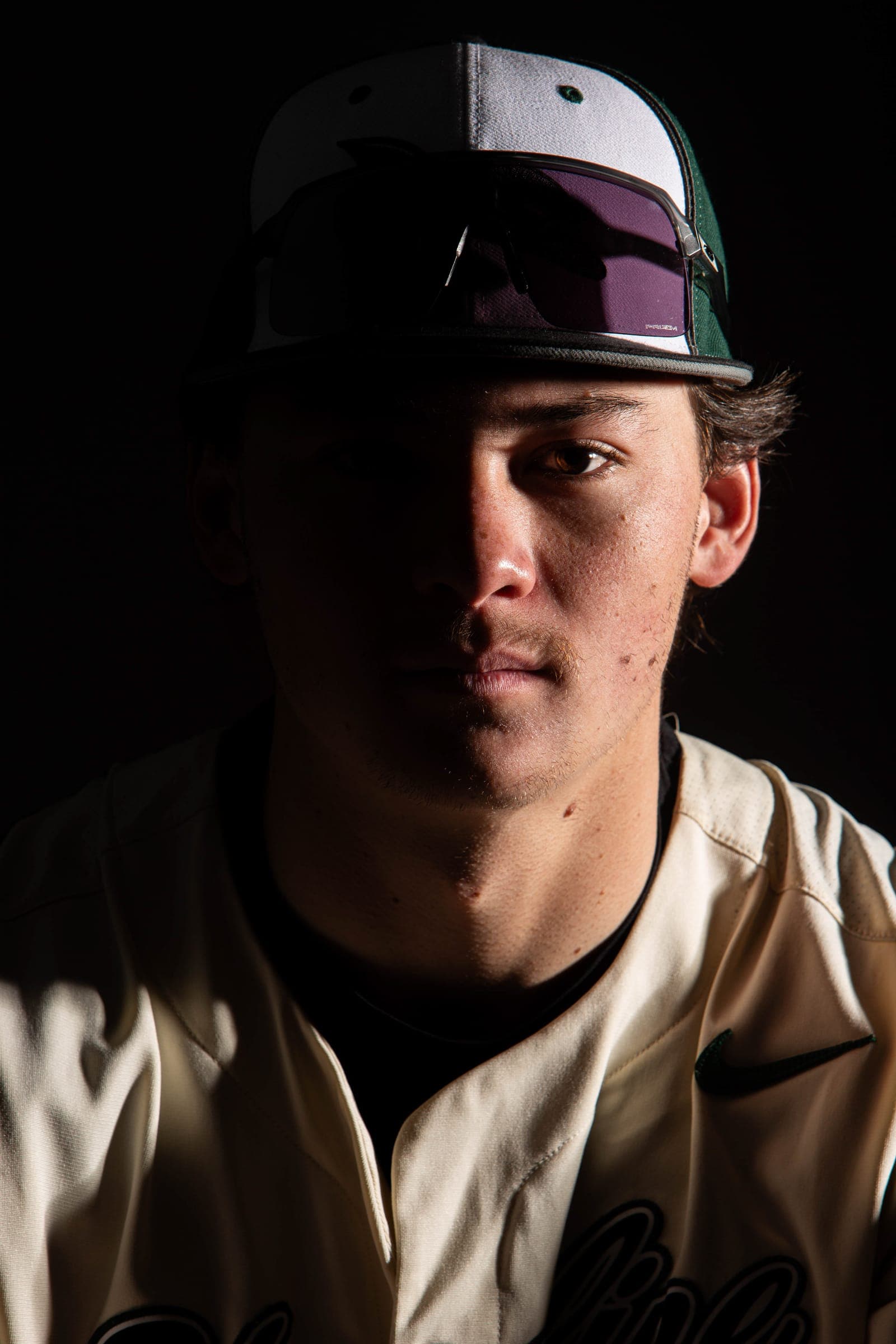 Moody close-up of a Shoreline player under the brim of his cap